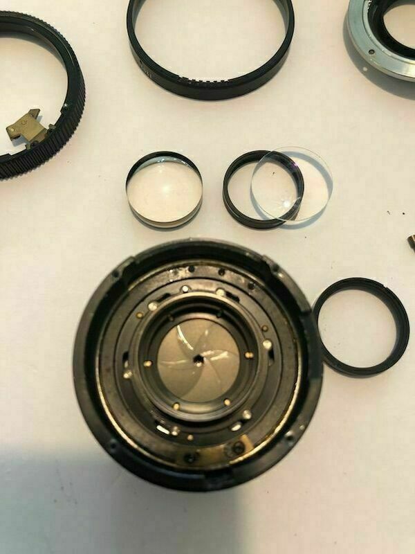 The last two lens elements are out and the diaphragm blades are visible.